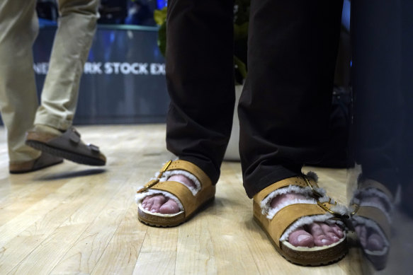 Traders on the floor of the New York Stock Exchange wear Birkenstock sandals during company’s IPO.